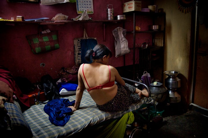 An HIV infected sex worker in a brothel in India. The women who work in this brothel may have between 20 to 50 customers per day. Sex with one of the women will cost about two dollars, of which half goes to the brothel owner.