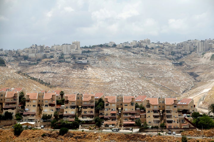 Houses are seen in the West Bank Jewish settlement of Maale Adumim as the Palestinian village of Al-Eizariya is seen in the b