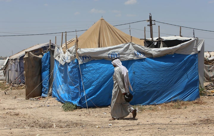 A displaced Iraqi man who fled fighting between government forces and the Islamic State (IS) group in Anbar province walks on May 31, 2015 at the Alexanzan camp in the Dora neighborhood on the southern outskirts of Baghdad on May 31, 2016. Only a few hundred families have managed to slip out of Anbar's Fallujah area ahead of the assault on the city.