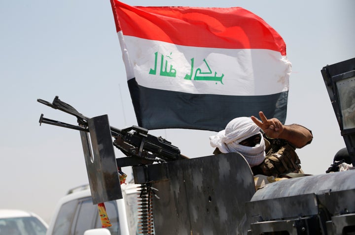 A member of Iraqi security forces gestures near Falluja, Iraq, May 31, 2016.