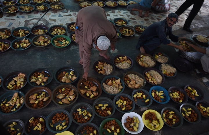 Pakistani volunteers prepare iftar food for devotees to break their Ramadan fast.