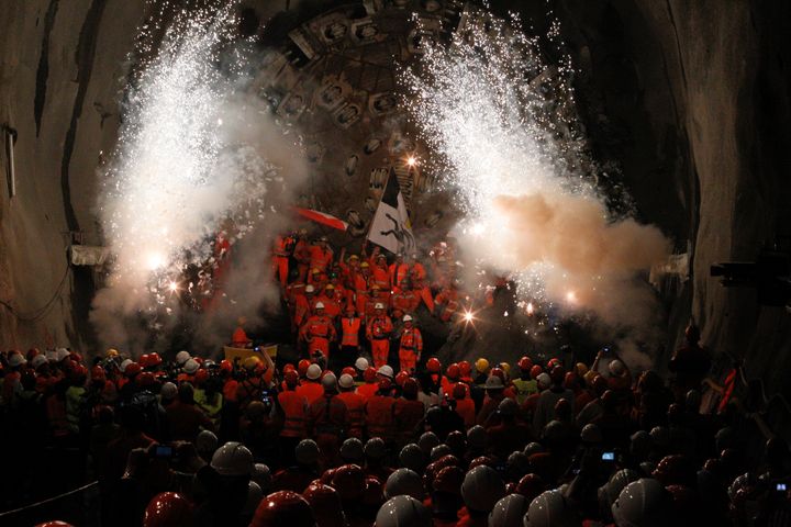 Miners celebrate breaking through the final section of the tunnel