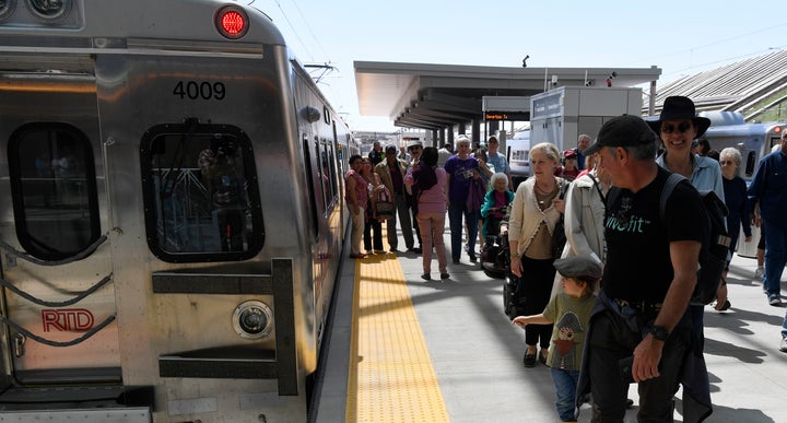 Passengers disembark from a train at the Denver International Airport, April 22, 2016. A new study argues that ride-hailing services like Lyft and Uber could increase people's use of public transit.