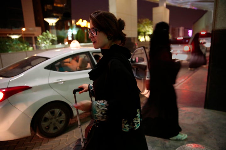 A woman waits for an Uber at a shopping mall in Riyadh, Saudi Arabia. Since women are not allowed to drive in the country, they must hire cars.