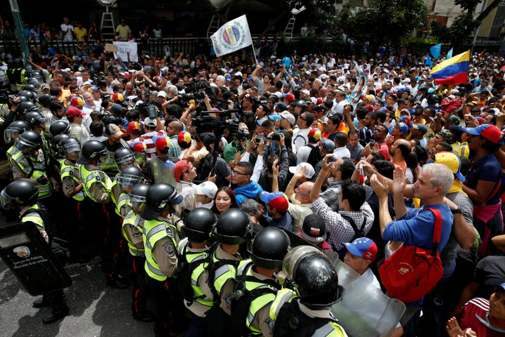 Opposition protesters clash with riot policemen as they demand a referendum to remove President Nicolás Maduro in Caracas, Venezuela, on May 18, 2016.