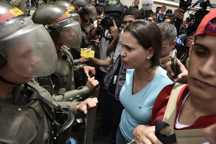 Protesters confront Venezuelan National Police officers during a demonstration for a referendum on the rule of President Nicolás Maduro in Caracas, Venezuela, on May 18, 2016.