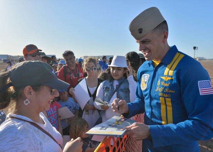 The U.S. Navy Flight Demonstration Squadron, the Blue Angels, opposing solo pilot Capt. Jeff Kuss signs a handout after the demonstration during the Naval Air Facility El Centro Airshow in March.