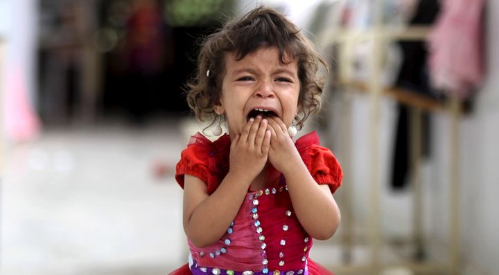 A girl cries at a school sheltering people displaced by Saudi-led air strikes on Yemen's northwestern province of Saada.