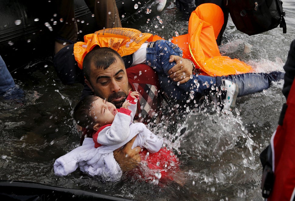 Image result for refugee father with child in water