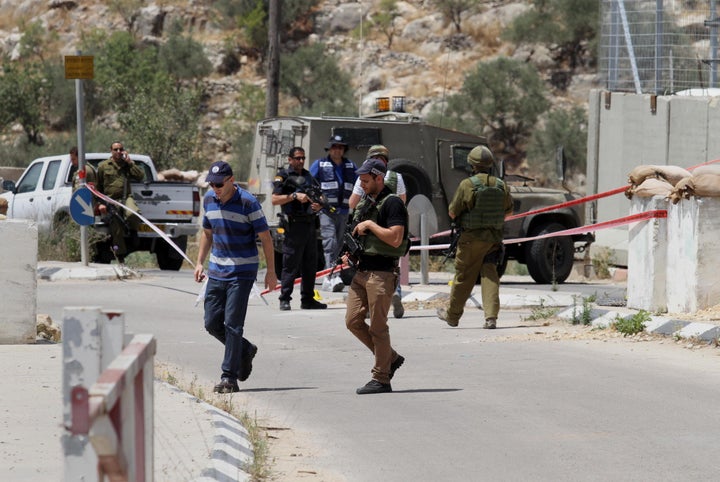 The French president said upheaval in the Middle East makes Israeli-Palestinian peace even more urgent. Above, Israeli security forces at a checkpoint east of the Tulkarm district of the West Bank on Thursday.