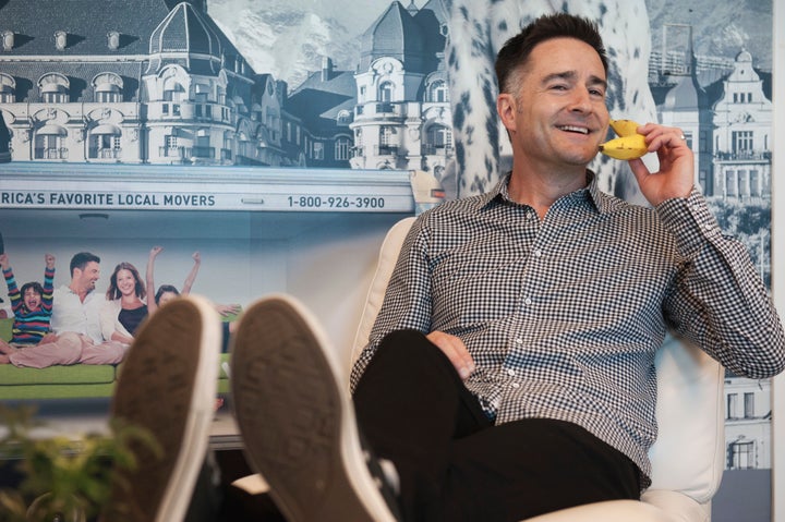 Brian Scudamore, CEO of O2e Brands on his banana phone at work.