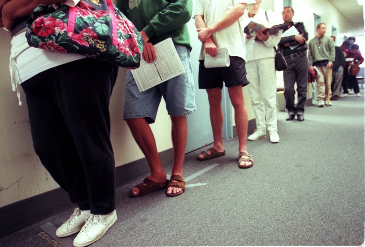 Applicants for food stamps line up in the hallway while they wait for their appointments with a counselor at the Dept of Social Services in Santa Ana. The rules for obtaining food stamps has changed with new restrictions on legal immigrants and the working poor. (Photo by Mark Boster/Los Angeles Times via Getty Images)