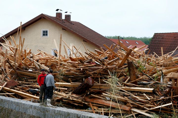 Residents look at debris caused by floods in the Bavarian village of Simbach am Inn, Germany, on June 2, 2016.