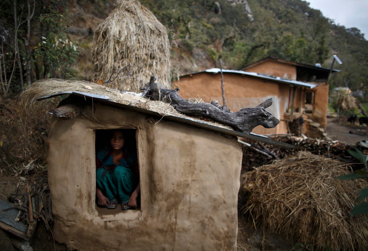 Uttara Saud, 14, sits inside a shed in western Nepal. Traditions observed in parts of Nepal cut women off from the rest of society when they are menstruating. Women have to sleep in sheds while they are on their period. They are not allowed to enter houses or temples, use normal public water sources, take part in festivals or touch others during their menstruation.