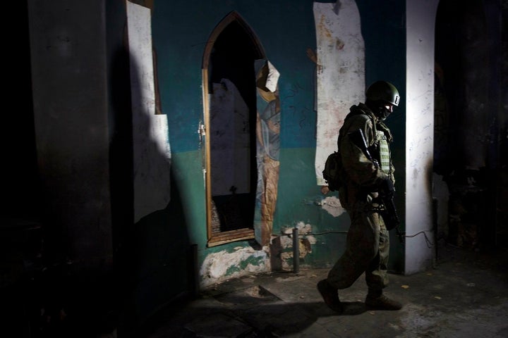 A Russian soldier, who escorted a group of journalists, walks inside a Greek Orthodox church in village of Maaloula on March