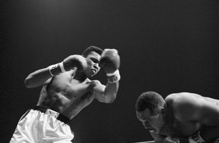 Cassius Clay (L) throws a punch to Archie Moore during a fight at the Sports Arena on November 15, 1962 in Los Angeles, California. Clay won by TKO.