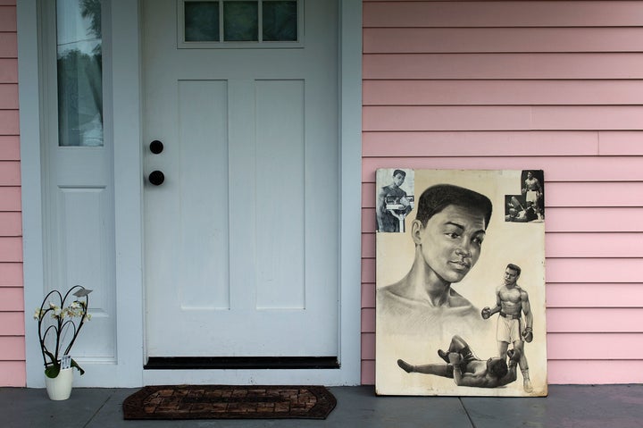 Illustrations depicting Muhammad Ali are seen at the door of his childhood home in Louisville, Kentucky