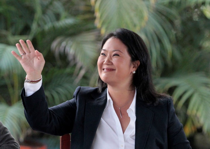 Peruvian presidential candidate Keiko Fujimori waves while arriving for a breakfast meeting in Lima, Peru, June 5, 2016.