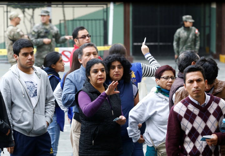 People stand in line to cast their votes in Peru's presidential election at a voting station in Lima, Peru, June 5, 2016.