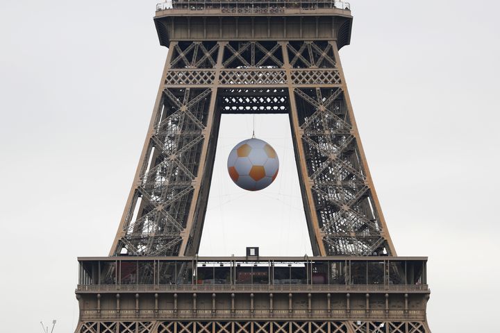 A football is suspended under the Eiffel Tower ahead of the start of the UEFA 2016 European Championship in Paris, France 