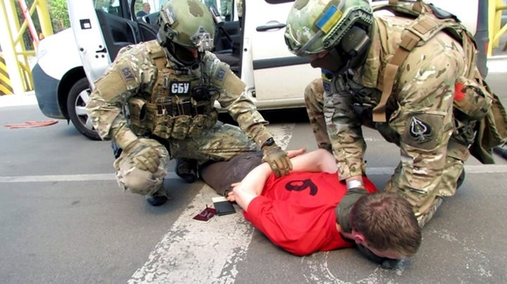 Members of Ukraine's state security service detain a French citizen who had been planning attacks in France to coincide with the Euro 2016 football championship it is hosting.