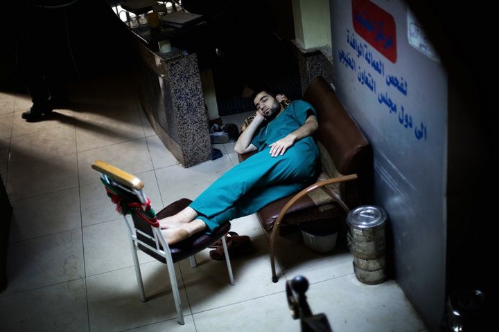 A Syrian doctor sleeps in the waiting room of Dar al-Shifa hospital in Aleppo on Oct. 21, 2012.