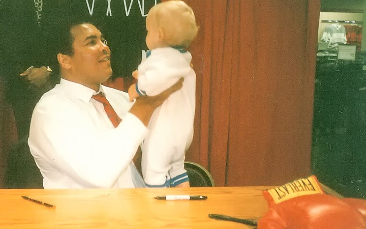 Muhammad Ali holds Riles Alexander, 10 months, during a promotional tour for his cologne at a Dallas, Texas department store in November 1989.