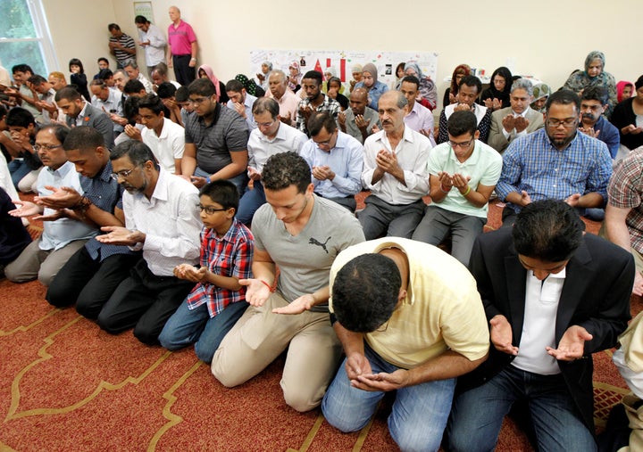 Members of the Louisville Islamic Center pray together before an interfaith service to honor Muhammad Ali.