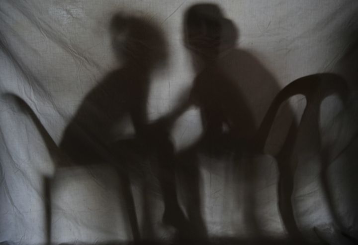 The shadow of two teenage girls rescued from a cyber sex den. Orders were streaming in when police barged in at a house in the Philippines, where naked girls on computers acted out the wild dreams of paying online voyeurs.