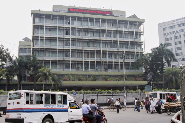 Commuters pass by the front of the Bangladesh central bank building in Dhaka March 8, 2016