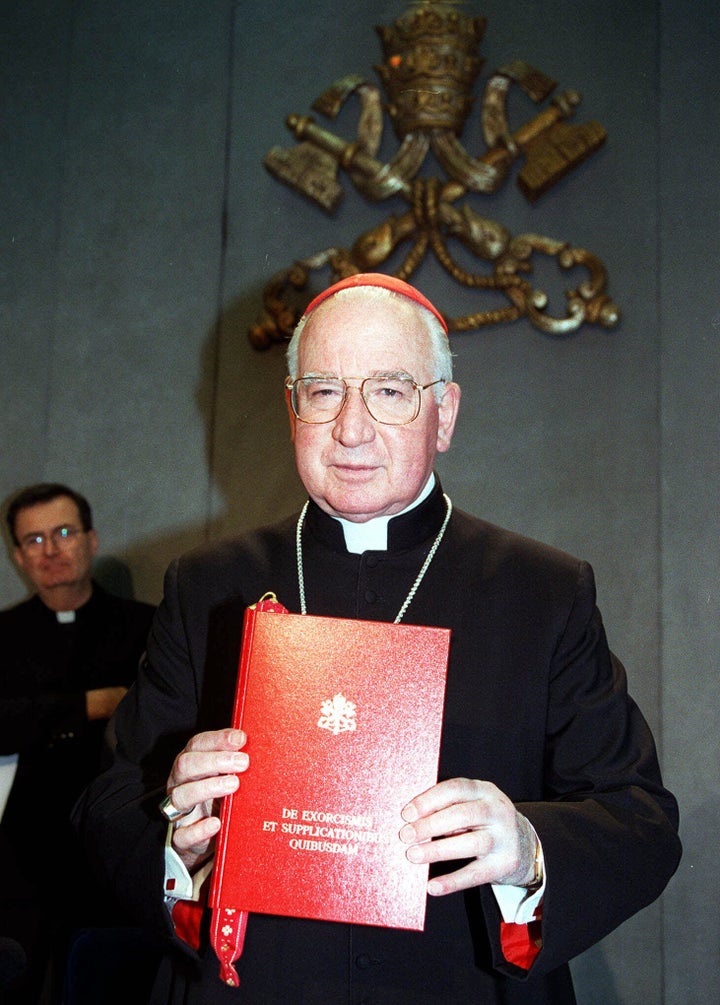 At the Vatican, Cardinal Jorge Medina Estevez, holds the Latan edition of <em>De Exorcismis et Supplicationibus Quibusdam</em> (<em>Of Exorcisms and Supplications</em>).