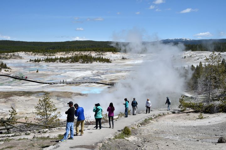 Tourists enjoy the view of the Norris Geyser Basin at Yellowstone National Park on May 12.