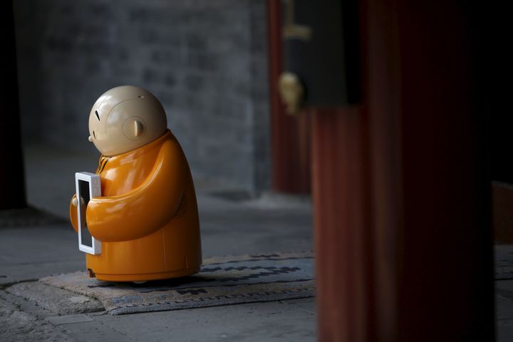 Robot Xian'er is placed in the main building of Longquan Buddhist temple for photographs by the temple's staff, on the outskirts of Beijing, April 20, 2016.