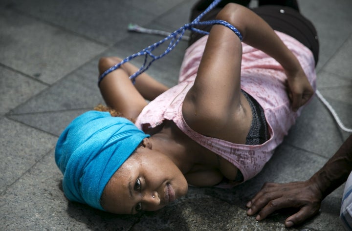 A U.N. inquiry on Wednesday said atrocities in Eritrea continue until today. Above, an Eritrean women in Israel simulates a torture technique at a protest in 2015.