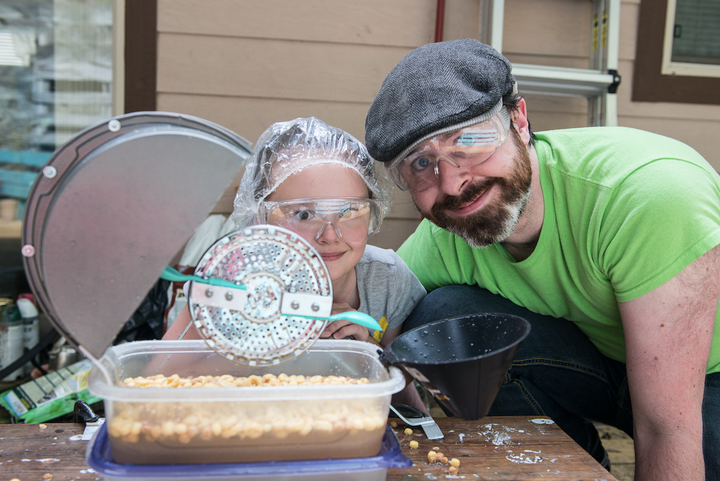 Ivan Owen with his daughter Torrae and their cereal-eating machine.