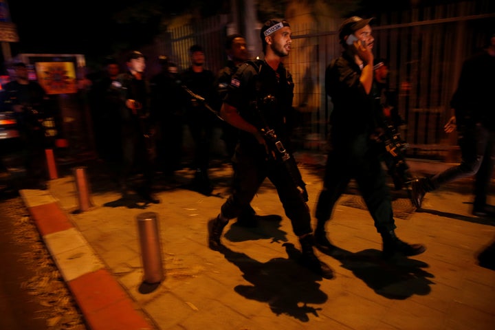 Israel security forces search the area following a shooting attack in the center of Tel Aviv on Wednesday.