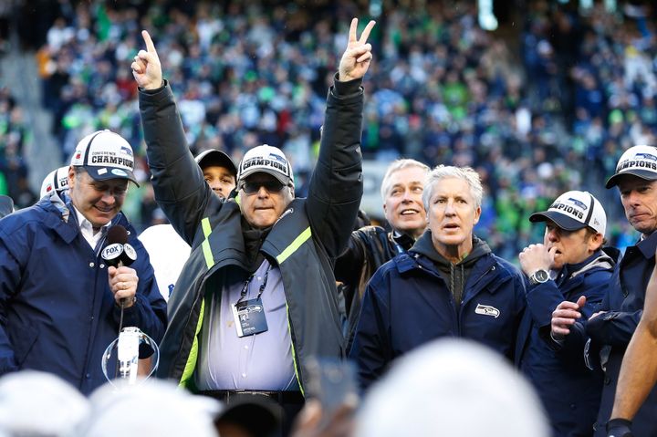 Seattle Seahawks owner Paul Allen and head coach Pete Carroll celebrate at CenturyLink Field after the Seahawks defeated the Green Bay Packers in the 2015 NFC Championship Game on Jan. 18, 2015.