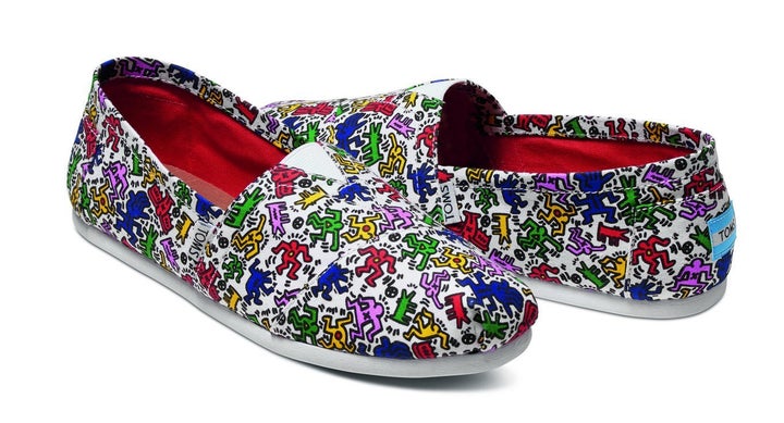 The new footwear features Haring's signature squiggles and stick figures. 