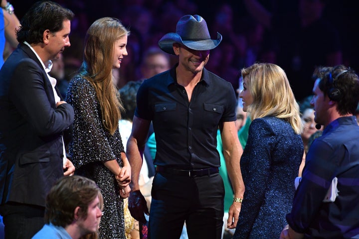 The two were spotted chatting with CMTs co-host, Erin Andrews.