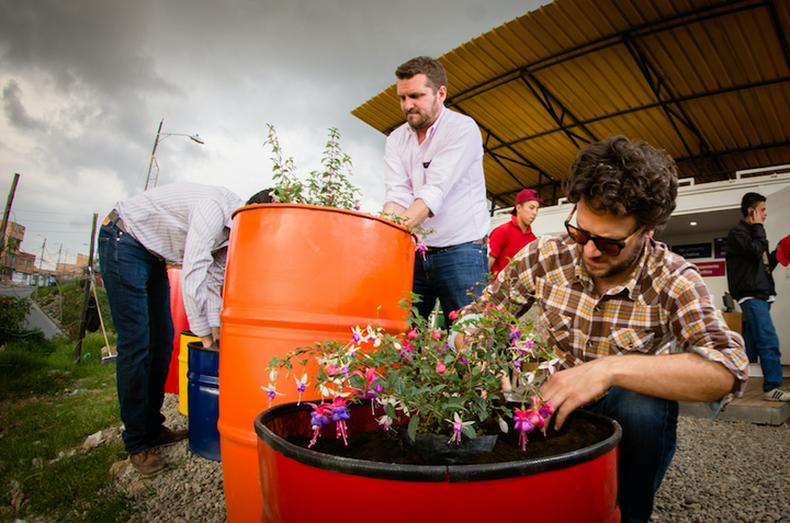 Volunteers plant flowers outside of Cazuca's Lab.