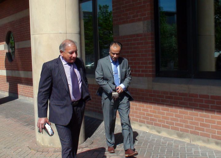Restaurant owner Mohammed Zaman (right) leaves Teesside Crown Court.