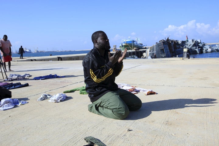 A man prays in a navy base in Tripoli after his boat sank off the coast of Libya in December.