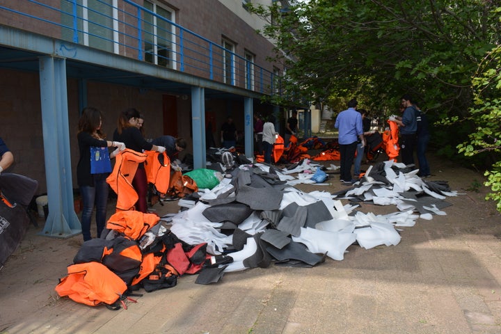 Students, staff and volunteers take the foam out of discarded life jackets.