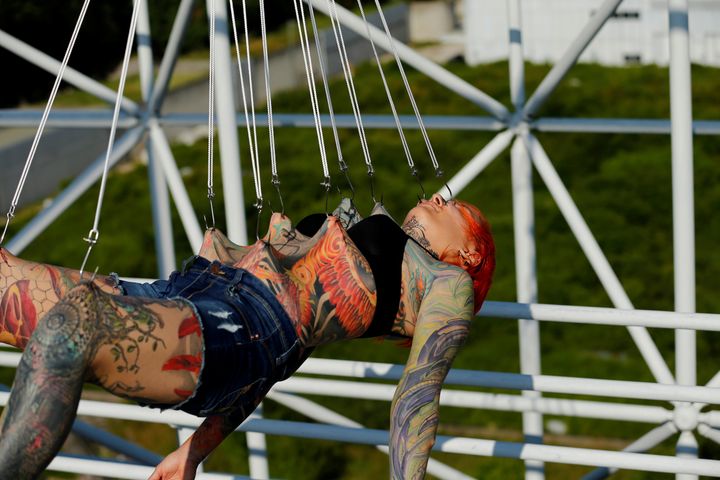 Kaitlin, 28, from the United States is suspended from hooks pierced through her skin by the professional body artist Dino Helvida in Zagreb, Croatia June 7, 2016.