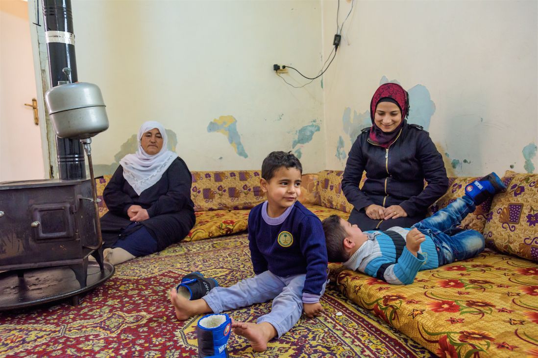 Haisha with her mother-in-law Fatima, and two of her four children. Her son Jamal (in the blue striped sweater) has an injured foot.
