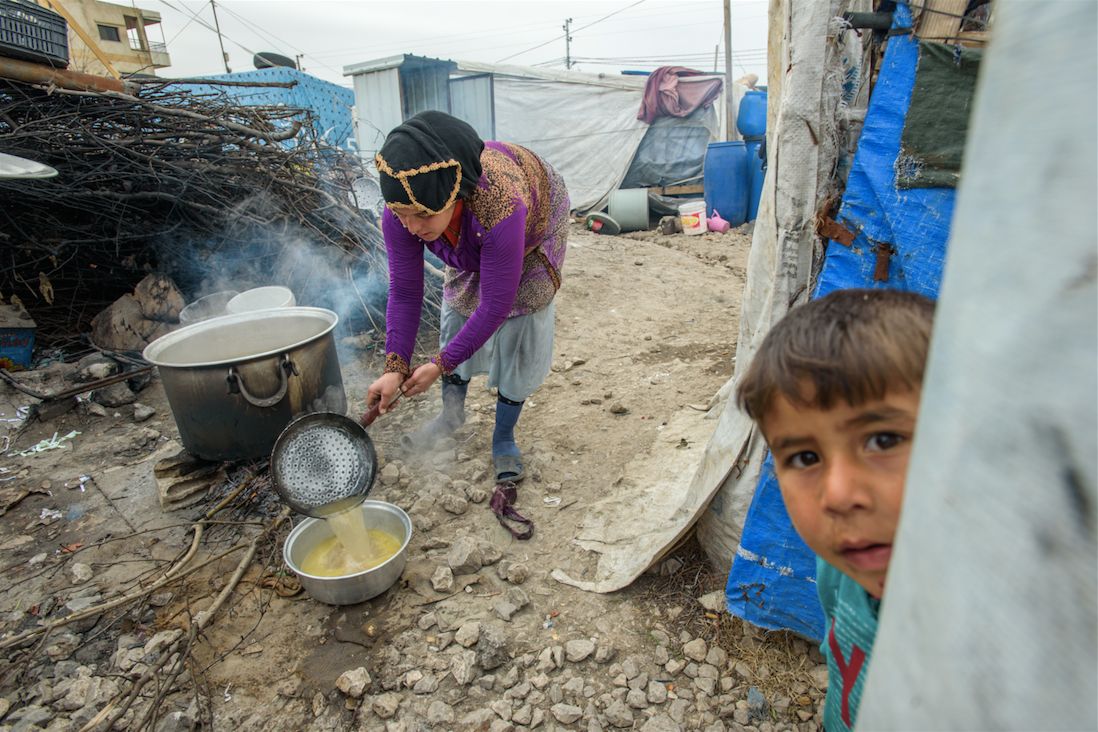 Woman cooking over an open fire, in the Bekaa Valley, Lebanon.