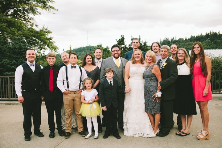 The author with "dad number one," her mom and family at her 2014 wedding. 