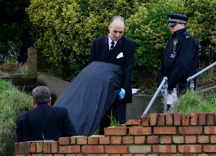 <strong>Police remove one of the bodies from the family home in Erith, Kent</strong>