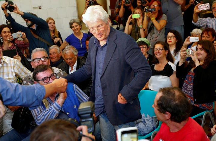 Richard Gere arrives to attend a news conference to present his movie "Time Out of Mind" in the soup kitchen run by the Sant'Egidio Christian community in Rome.