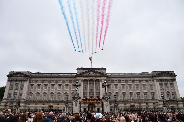 Members of the royal family line the balcony of Buckingham Palace as the Red Arrows perform a fly-past.